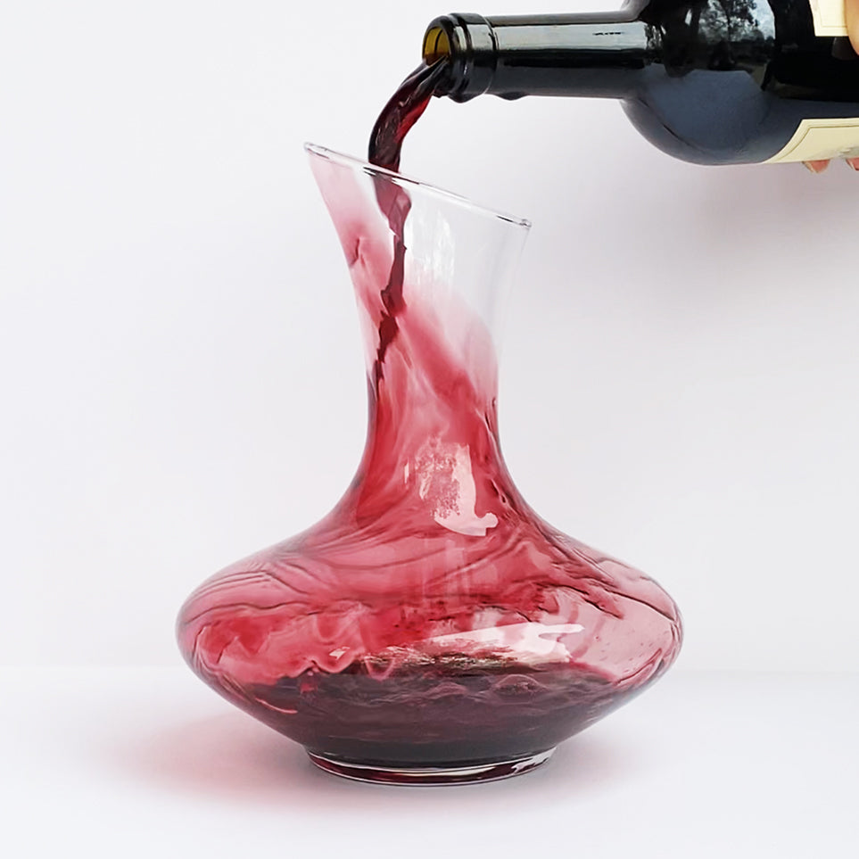 Aerisi Wine Aerator  Glass Decanter with red wine being poured into it on white background